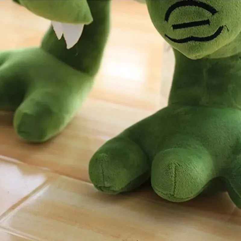 cadeau anniversaire peluche dinosaure vert pattes gros plan